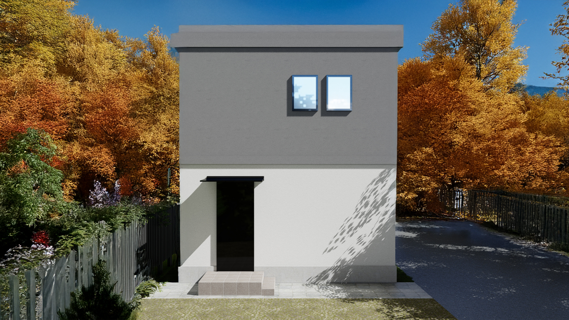 紅葉に囲まれたコンクリート住宅の外観
